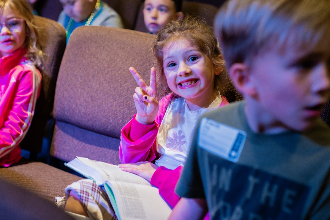 A young girl smiling with her Bible