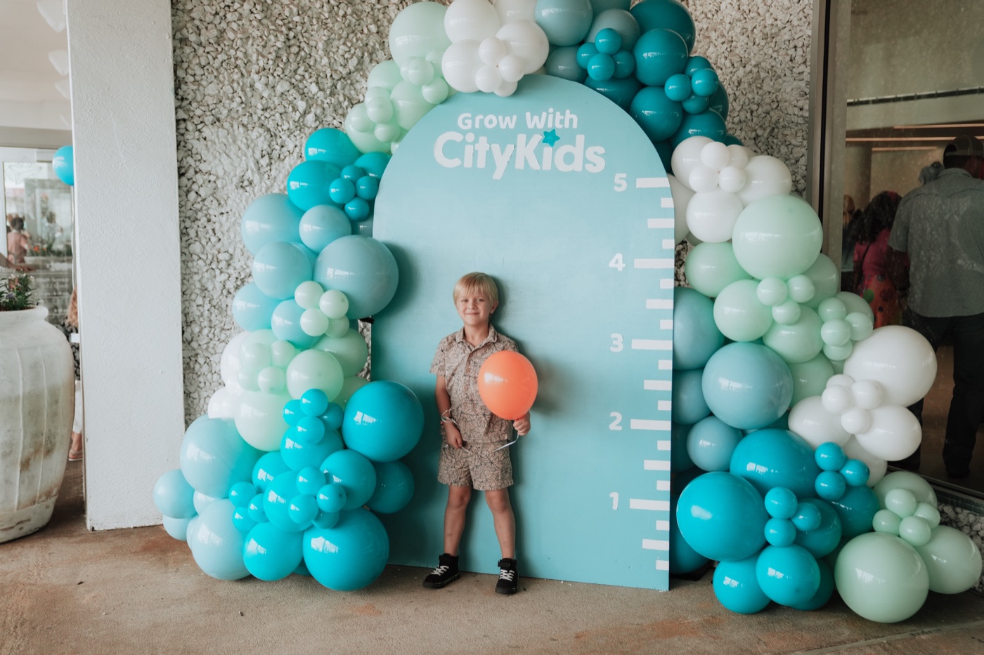 A child at the Grow With CityKids arch