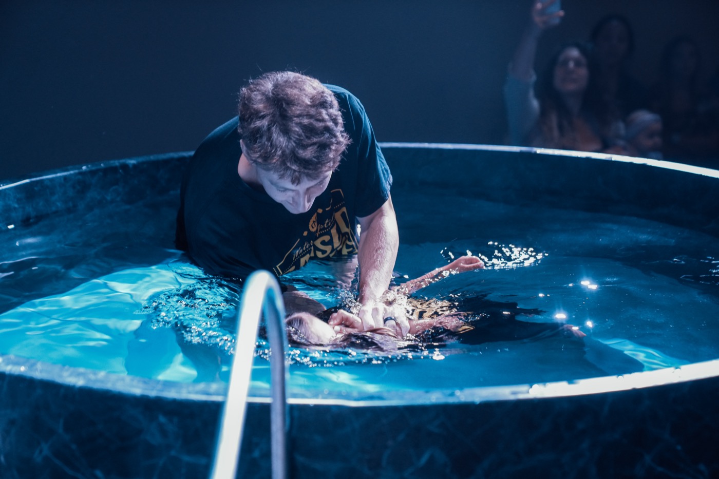 Child being baptized in the Citymark baptism tank