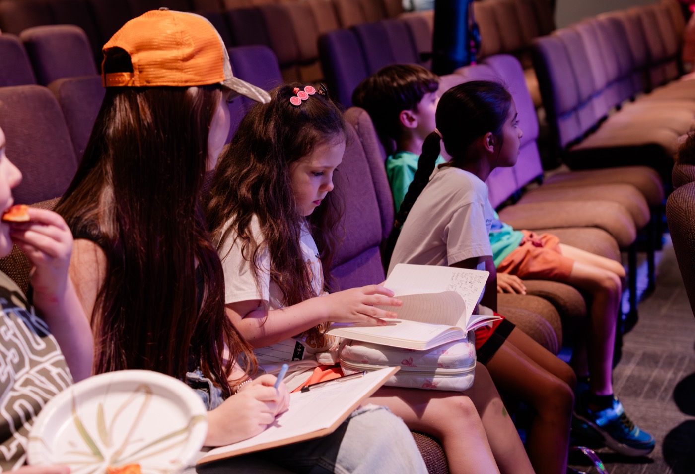 CityKids student writing in journal during service