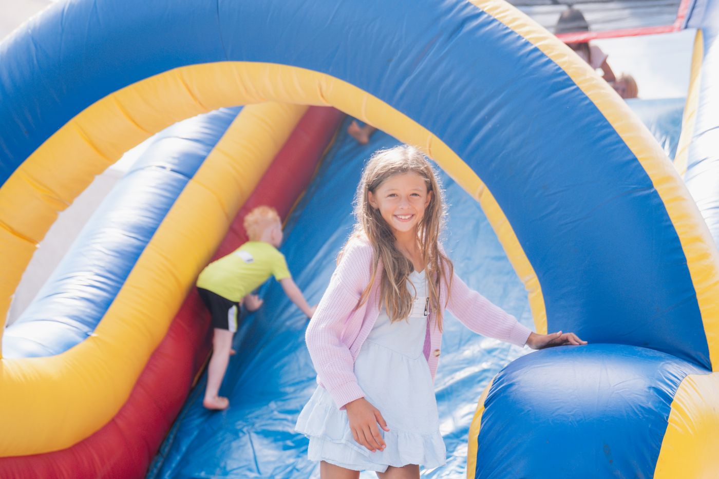 Kids playing on an inflatable at a CityKids event