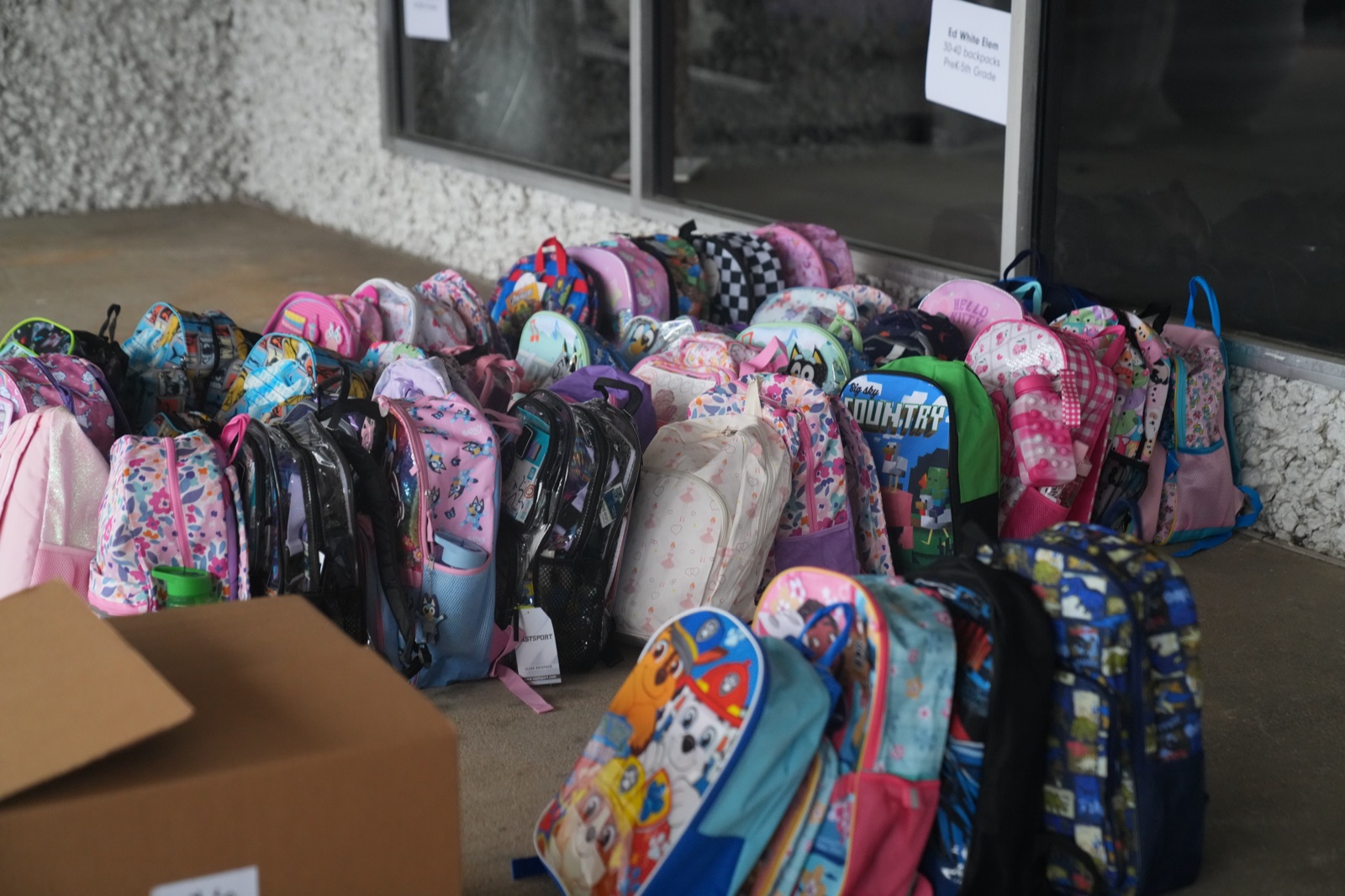 Backpacks lined up at Citymark for Back to School Blessed