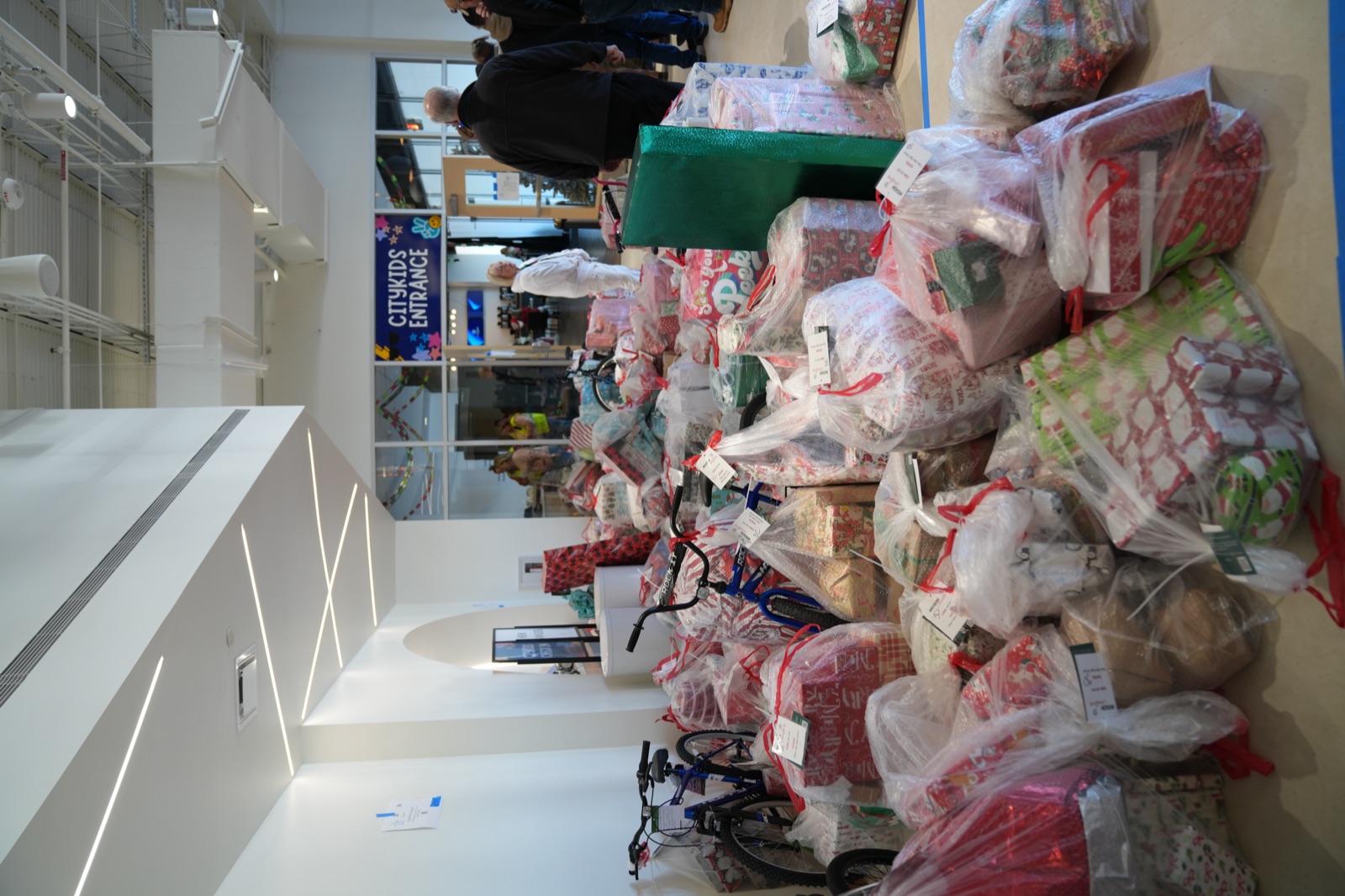 Wrapped gifts piled at Citymark for Mission Christmas